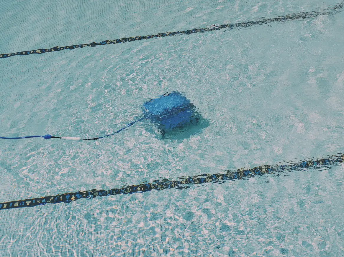 A robotic cleaner working on a pool floor